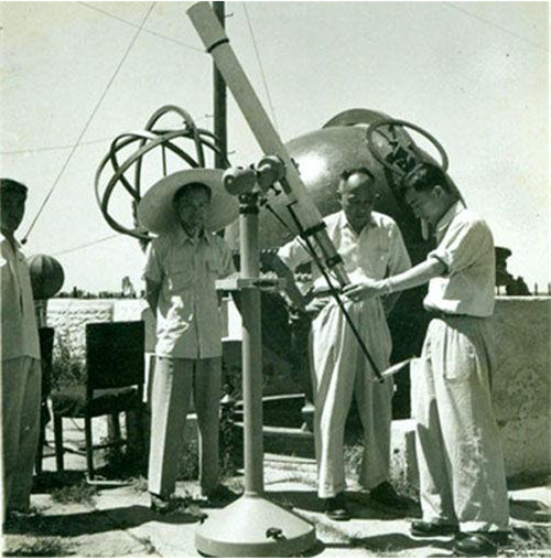 陈遵妫馆长(右二)和李元(右一)正在用望远镜观测日食投影像.png